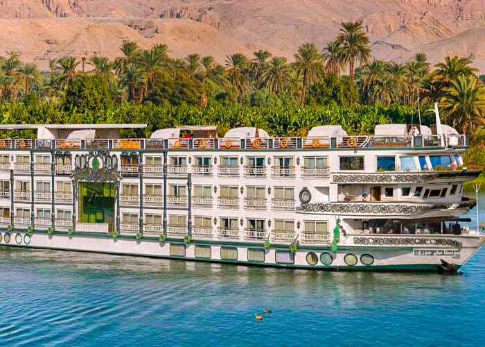 Sonesta St. George I Cruise boat on the Nile River, showcasing a scenic view of the river and surrounding landscape.