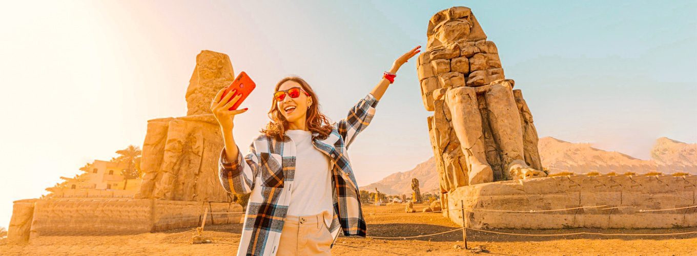 A traveller at the Colossi of Memnon in Luxor, where the Nile cruise begins